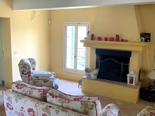 a living room with a couch and a fireplace at Casale IL SAMBUCO sui colli bolognesi in San Lazzaro di Savena