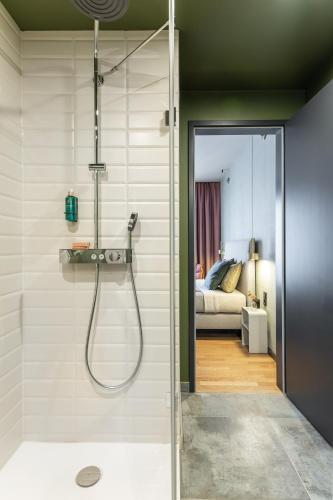 a bathroom with a shower and a bedroom at ipartment Berlin Airport in Schönefeld