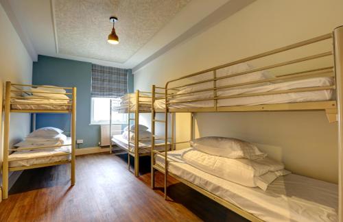 a room with two bunk beds and a window at PubLove @ The Exmouth Arms, Euston in London