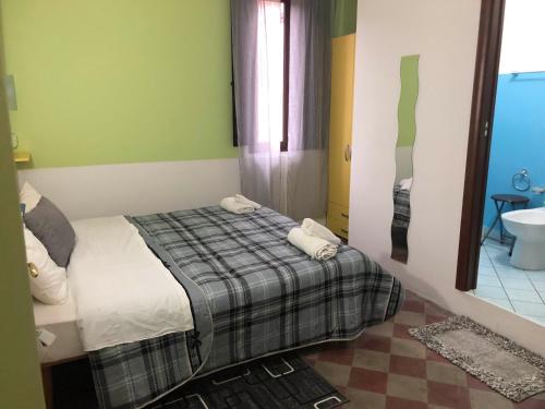 a bedroom with a bed with two towels on it at B&B L'Alba in Gagliato