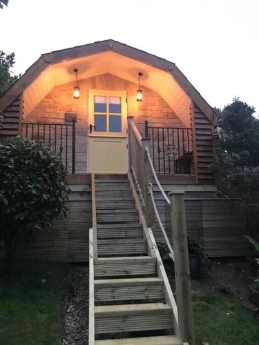 a small cabin with stairs leading to a door at Bumble Bee Cottage in Plymouth