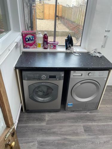 a washing machine sitting next to a window at Perfect room 1 in Bristol