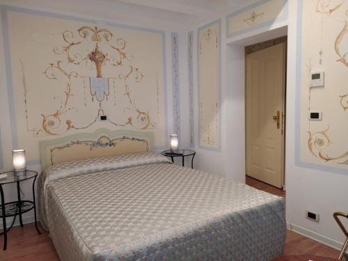 a bedroom with a bed and two tables and a door at Hotel Antigo Trovatore in Venice
