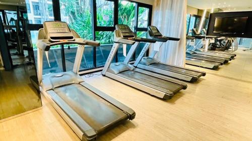 a row of treadmills in a gym at The base Central Pattaya 631 by Numam in Pattaya Central