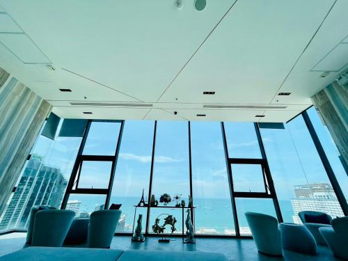 a room with chairs and a large group of windows at The base Central Pattaya 631 by Numam in Pattaya Central