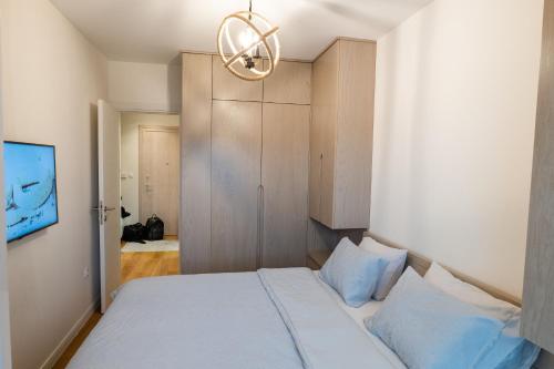 a bedroom with a bed and a chandelier at Luxury AMAAA Apartment in Bar