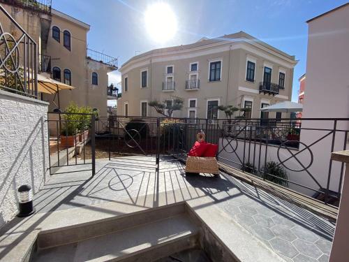 a woman sitting in a chair on the balcony of a building at Zara Palace in Scafati