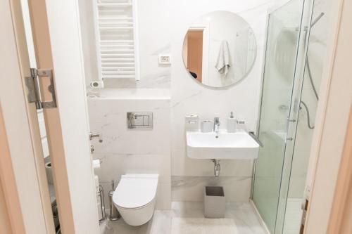 a bathroom with a toilet and a sink and a shower at Luxury AMAAA Apartment in Bar