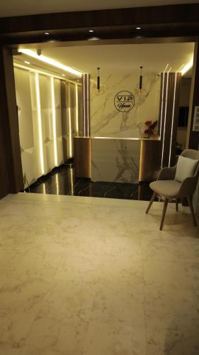 a room with a couch and a chair and a wall at Vip House Résidence in Sousse