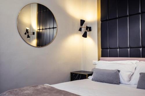 a bedroom with a mirror and a bed at Ricasoli Garden Relais in Florence