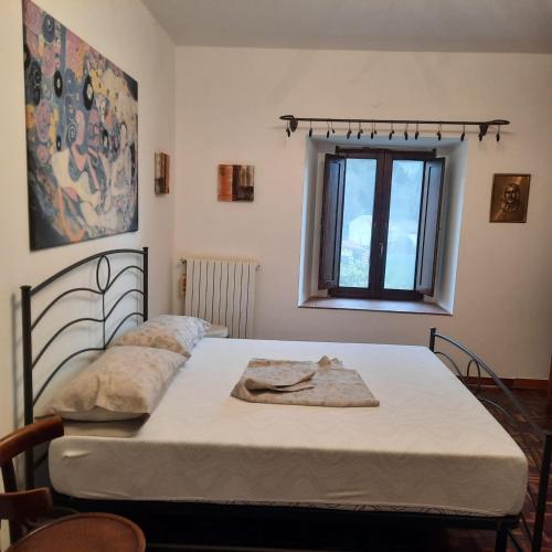 a bedroom with two beds and a window at LA MACINA 