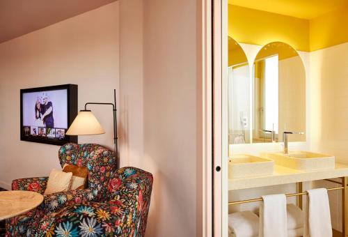 a living room with a chair and a sink at Mama Shelter Roma in Rome