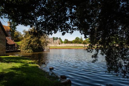 a view of a lake with a castle in the background at The Montagu Arms in Beaulieu