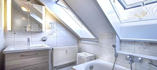 a bathroom with a sink and a skylight at FeWo Finkenberg Freudenstadt in Freudenstadt