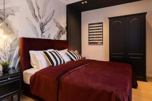 a bedroom with a bed and a black cabinet at Candy Ballerina No 3 Zagreb Center - top positon Lux in Zagreb