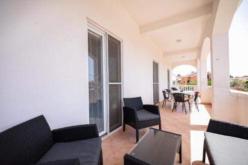 a living room with a couch and chairs and a table at Apartments Marina in Petrcane