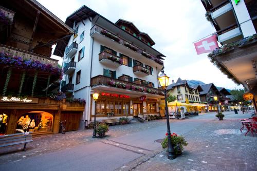 a city street with buildings and a light pole at Sporthotel Victoria in Gstaad
