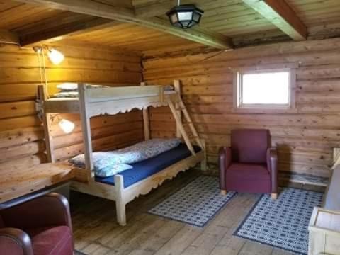 a bedroom with a bunk bed in a log cabin at Børte gård in Lunde