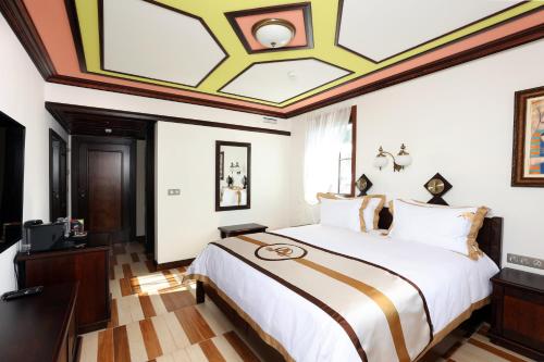 a bedroom with a large bed with a coffered ceiling at Armaco Residence in Koprivshtitsa