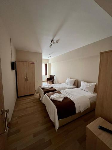 a large bedroom with two beds in a room at Akar Pansiyon in Canakkale