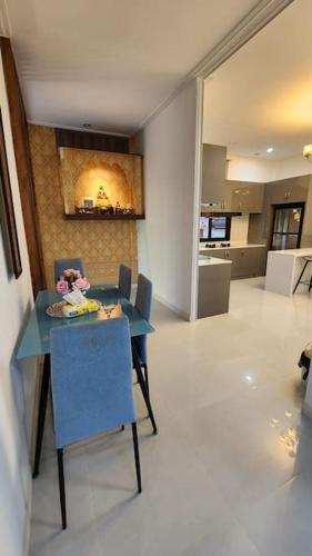 a dining room with a blue table and chairs at Ying Yang House Sawankhalok in Sawankhalok