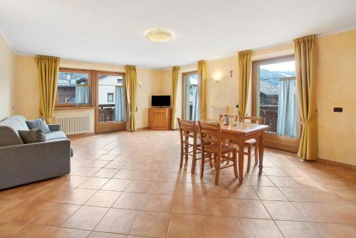 a living room with a table and chairs and a couch at Chalet Anna Sclopet in Livigno