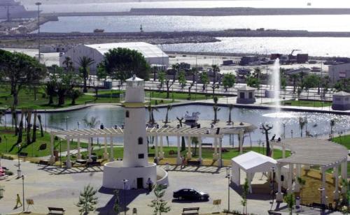 a view of a park with a fountain and a lighthouse at AYALA APARTAMENTO in Málaga