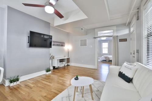 a white living room with a white couch and a tv at **NEW RADiant Stay in the Thrust of OTR* w/Parking in Cincinnati