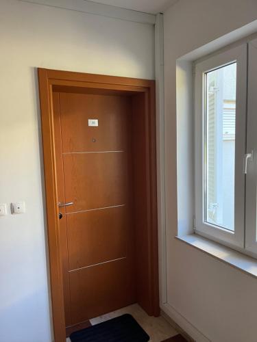 a wooden door in a room with a window at Modern Apartment Selce in Selce