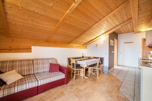 a living room with a couch and a table at Lingerhof Arnika in Meltina
