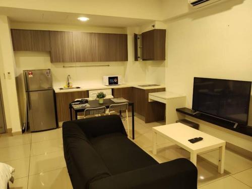 Il comprend un salon avec un canapé et une cuisine. dans l'établissement HB1516- Two queen bed-Wifi-Netflix- Parking- Cyberjaya, 3056, à Cyberjaya