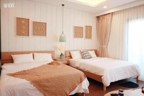 Postel nebo postele na pokoji v ubytování Quy Nhon Chillin' Apartment - FLC Sea Căn Hộ Hướng Biển Trung Tâm TP