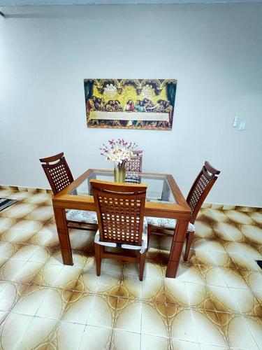 a dining room table with two chairs and a glass table at Divino Espírito Santo in Aparecida
