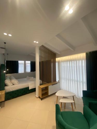 a bedroom with a bed and a table and chairs at Qeparo Napolon Complex in Qeparo