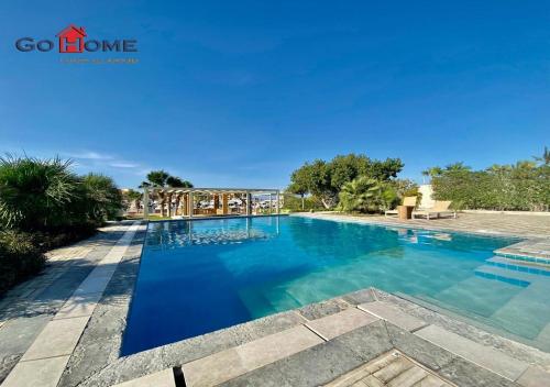 una piscina en un complejo con agua azul en Stylish 5B Room MB04@ New Marina en Hurghada