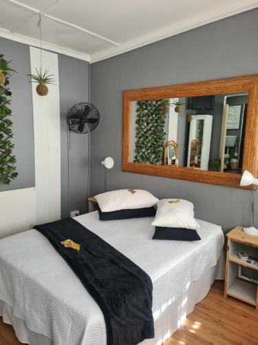 a bedroom with two beds and a large mirror at Prosper Stud Guest House in Robertson