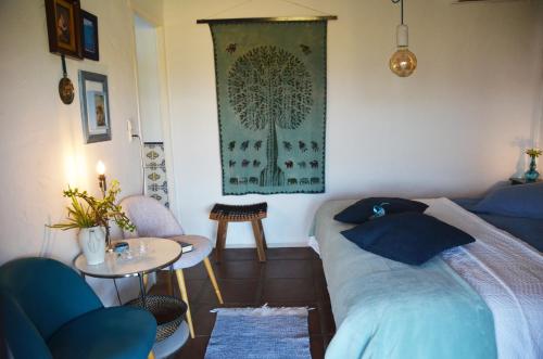 a bedroom with a bed and a small table and a table at B&B Finca Alegria de la Vida in Pizarra