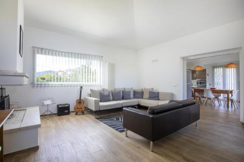 a living room with a couch and a table at The White Villa in Tortolì