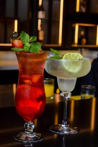 two cocktails are sitting on a table with at Lidotel Caracas in Caracas