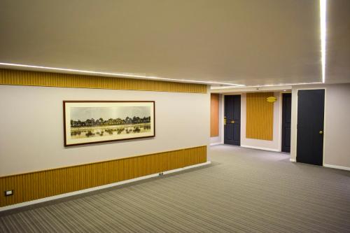 a hallway with a painting on the wall at Lidotel Caracas in Caracas