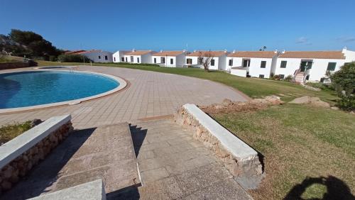 a house with a swimming pool in a yard at Costa Arenal 112 in Arenal d'en Castell