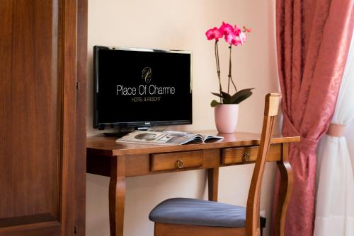 a desk with a computer monitor on top of it at Certosa di Pontignano Residenza d'Epoca - Place of Charme in Ponte A Bozzone