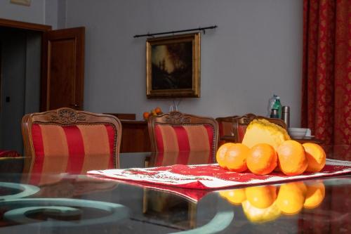 a dining room table with oranges on top of it at Le Stanze Del Vicerè Boutique Hotel in Naples