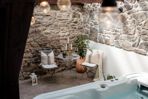 a bathroom with a tub and a table and chairs at Hazai Provence in Kapolcs