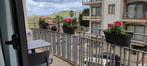 a balcony with potted plants on a building at Bright Stylish Apartment in Victoria