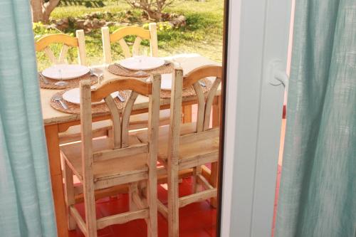 a table with chairs and plates on top of it at Yucas Homes in Cala en Blanes