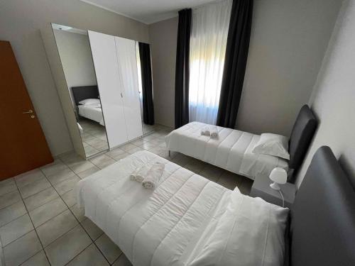 a hotel room with two beds and a mirror at Residence Verona Inn in Verona