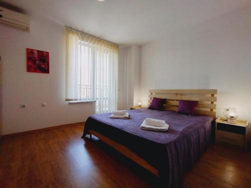 a bedroom with a bed with two towels on it at Apartament Panorama - BastetBS in Sveti Vlas