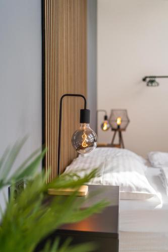 a bedroom with a bed and a lamp on a table at MyFlat - Bright Apartment near Central Station in Vienna