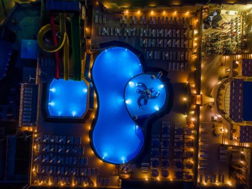 a letter j lit up in blue at night at Elounda Residence Resort & Waterpark in Elounda